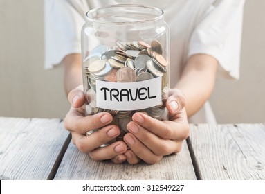 Women hold money jar with coins on wood table , Saving for Travel Concept - Powered by Shutterstock