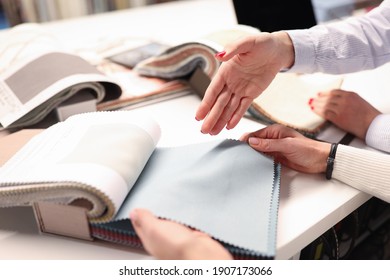 Women Holding Catalog And Choosing Fabrics Closeup. Designer Tips Concept