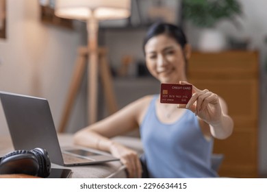 Women holding credit card and using laptop at home.Online shopping, internet banking, store online, payment, spending money, e-commerce payment at the store, credit card, concept