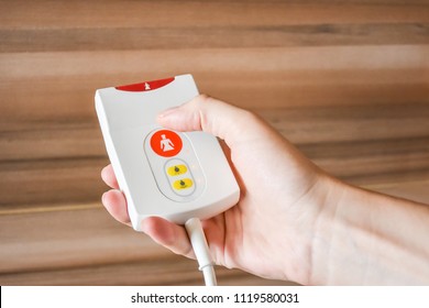 Women holding in the hand emergency button in hospital. Hands press the Nurse call system in hospital. Clinic, healthcare, medical electronic communication equipment. First aid of medical staff
