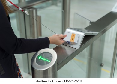 Women Holding Key Card Access Control To Unlock Security At An Entrance Gate 