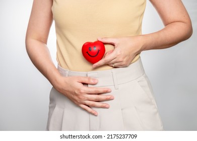 women holding smile heart shaped souvenir on the belly. Pregnancy about 1-2 months. Concept successful treatment IUI Intra – Uterine Insemination and ICSI. infertility Concept.
 - Shutterstock ID 2175237709