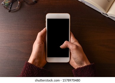 Women Holding White Smartphone Close Up - First Person Perspective.