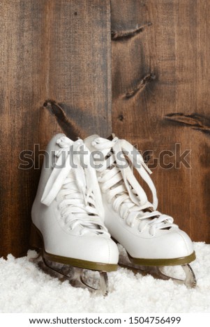 women ice skates with wood wall