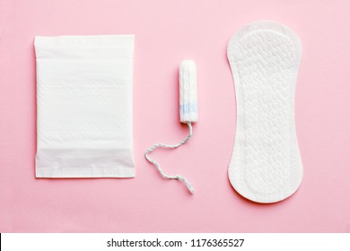 women intimate hygiene products - sanitary pads and tampon on pink background