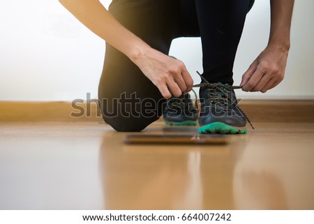 women jogger tying her shoes