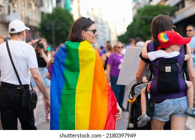 Women With Kids And Rainbow Flag At Pride. Real People At Pride Parade Event, Supporting The Rights Of LGBTQIA Community And Celebrating Freedom With Rainbow Flags - VALENCIA, SPAIN: 25 JUNE 2022