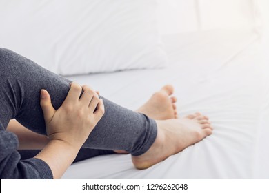 women lag pain on bed in bed room in the morning.color tone. - Powered by Shutterstock