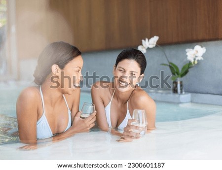 Women laughing in hot tub at spa