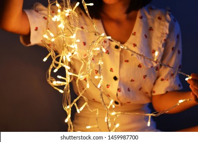 Women with LED String Light and illuminated at night - Powered by Shutterstock