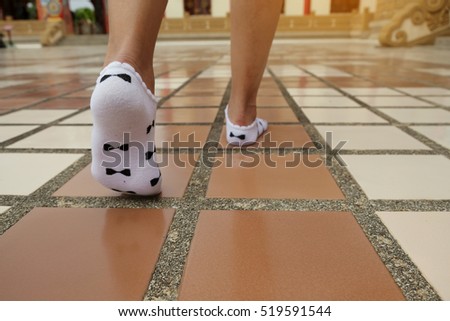 women leg Foot wear sock walking on the cement floor