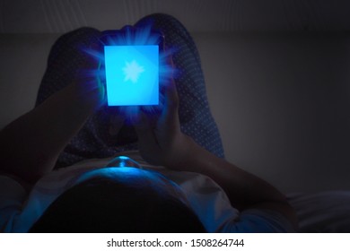 Women Looking At Mobile Phones In Low Light And The Blue Light From The Phone Has Bad Effects On The Eyes.