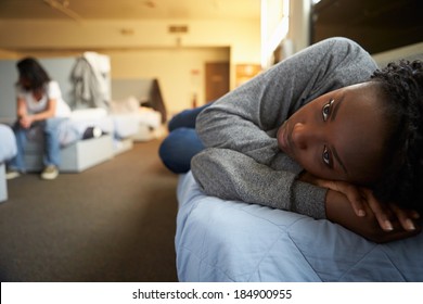Women Lying On Beds In Homeless Shelter