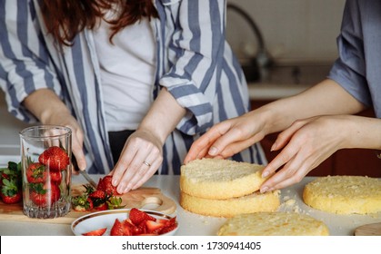 Women Make A Cake: Cut Strawberries Into Fillings And Prepare Layers Of Sponge Cake. Hands In The Frame. Homemade Cake With Berry Filling. Series