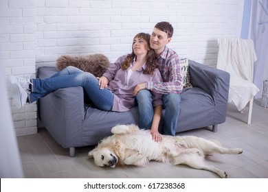 Women, man and their dog relaxing at home - Shutterstock ID 617238368