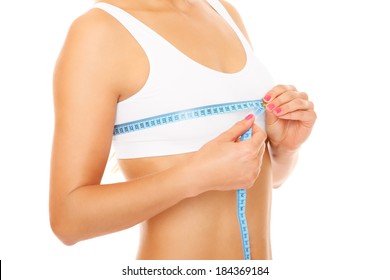 Women measures size of breast over white background