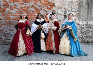 Women In Medieval Clothes Represent  Wives Of King Henry VIII Of England. Festival Of Retro Costumes And Historical Reconstructions. History Of The Middle Ages