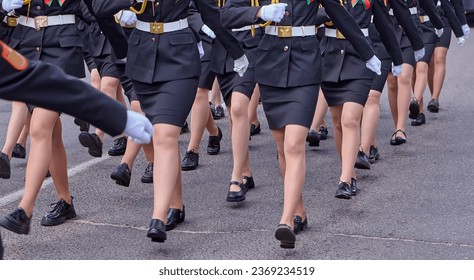 Women in military uniform at a military parade. Women's legs, black skirts.