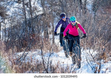 Women Mountain Biking On Fat Bikes In The Winter