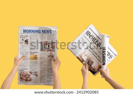 Women with newspapers on yellow background