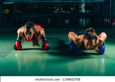 Women on boxing training doing push ups - Powered by Shutterstock