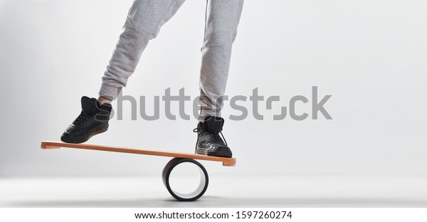 Women on Deck for\
balance board. Rocker-roller boards. Isolated oval wooden deck for\
balance board. solid plastic roller for balance board.\
Rocker-roller boards.\
Isolated