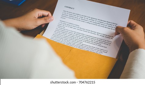 Women are opening an envelope document about signing a contract in business and sign contract concept,vintage style  - Shutterstock ID 704762215