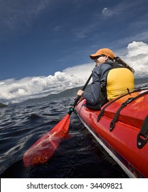 Women Paddling A Sea Kayak