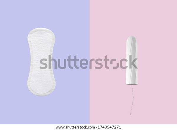 women pads and\
tampon - sanitary pads lies next to a tampon on an isolated\
background on a pink and violet  background. Women\'s hygiene and \
menstrual period concept.