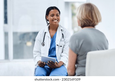 Women, patient and doctor with a tablet, consultation and conversation for diagnosis, cure and treatment. Medical professional, employee and female person in a hospital, technology and discussion - Powered by Shutterstock