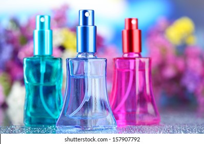 Women perfume in beautiful bottles and flowers 