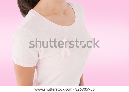 Women in pink for breast cancer awareness against white background with vignette