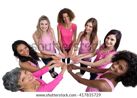 Women in pink outfits joining in a circle on white background for breast cancer awareness