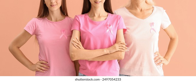 Women with pink ribbons on beige background. Breast cancer awareness - Powered by Shutterstock