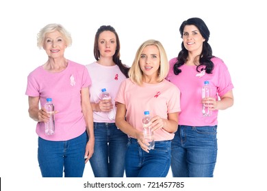 women in pink t-shirts with ribbons holding bottles of water and smiling at camera isolated on white - Powered by Shutterstock