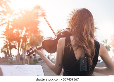 Women Play Violin As An Instrument To Express The Melody Is Playing Outdoor Music Talent Show.