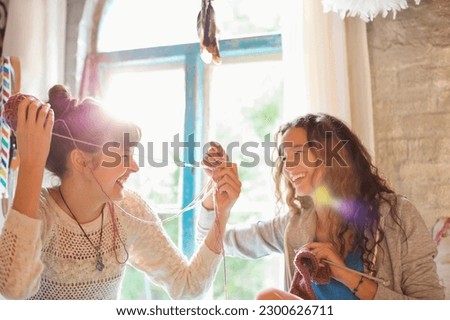 Women playing with yarn together