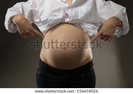women points to the bottom of his belly Stock photo © 