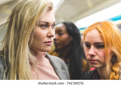 Women Portrait On Crowded Tube Train. Busy Subway Carriage At Rush Hour, Multicultural People Standing Next Each Other. Travel And Lifestyle Concepts