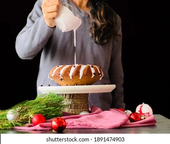 Women Pours Blueberry Sauce Over Blueberry Bundt Cake. Front View