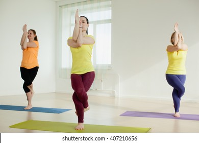 women practicing the eagle pose