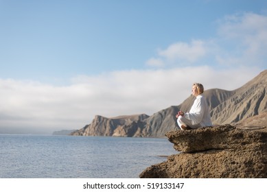 Women practicing Taijiquan in beautiful nature. Meditation in morning day on the sea coast