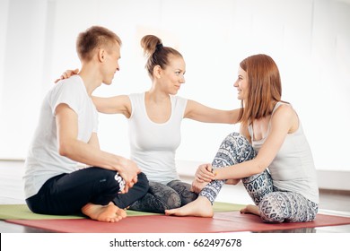 Women Practicing Yoga At Health Club. Young Girls Talking And Relaxing After Fitness, Yoga Instructor Speaks On The Phone After Training, Lifestyle Concept