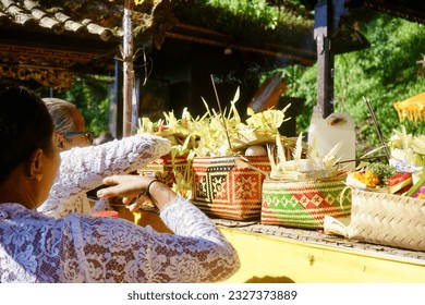 Women are preparing an offering for prayer at a temple on the slopes of Mount Agung, “Pura Pejinengan Tap Sai” Bali.