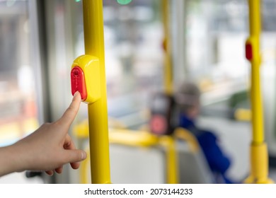 The Women Pressing Stop Request Button On The Bus To Get Off.