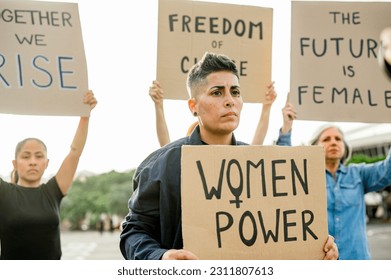 Women protesting with placards on street - Shutterstock ID 2311807613