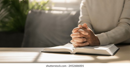 Women put their hands together and pray to God with the scriptures. Belief in God. Belief. Hope. Love. Solitary watch during the holidays. Ready to spend time with God - Powered by Shutterstock