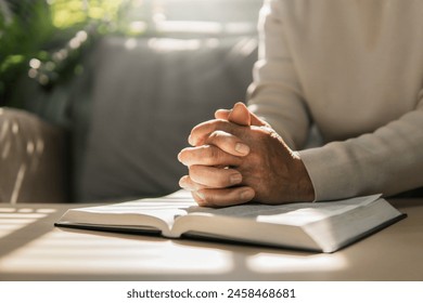 Women put their hands together and pray to God with the scriptures. Belief in God. Belief. Hope. Love. Solitary watch during the holidays. Ready to spend time with God - Powered by Shutterstock