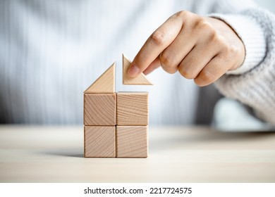 women putting triangle wooden block for show the construction of a wooden in the shape of a house, insurance business, real estate agent
build a home concept. - Powered by Shutterstock