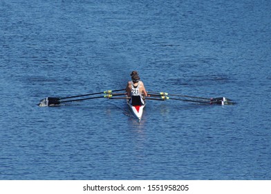 Women racing sculling on a sunny day and blue waters - Powered by Shutterstock